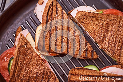 Homemade sandwiches lie on the groa grill Stock Photo