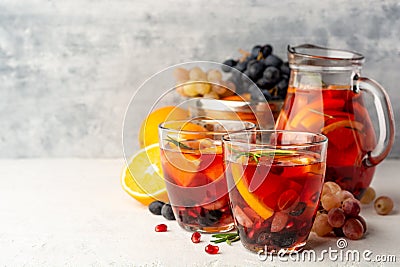 Homemade sangria with orange, grapes and pomegranate seeds in glasses on concrete background Stock Photo