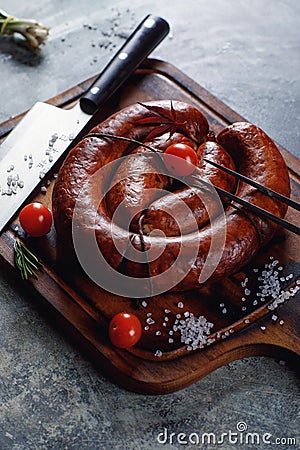 Homemade sausage cooked on a grill, with tomatoes. Stock Photo