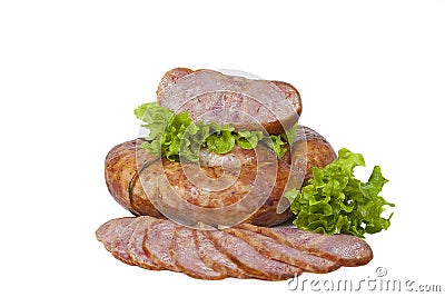 Homemade sausage, partially sliced, decorated with lettuce leaves. Isolated on white background Stock Photo