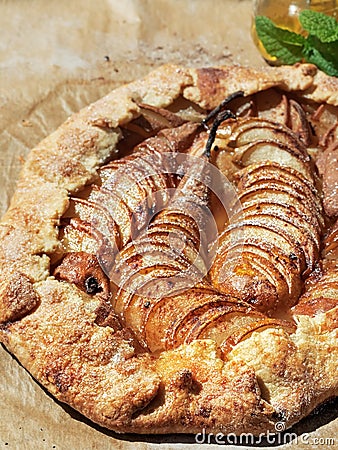 Homemade seasonal French pear cookies - galette with ripe pears, cardamom and honey. A baked galette with pears and spices on a Stock Photo