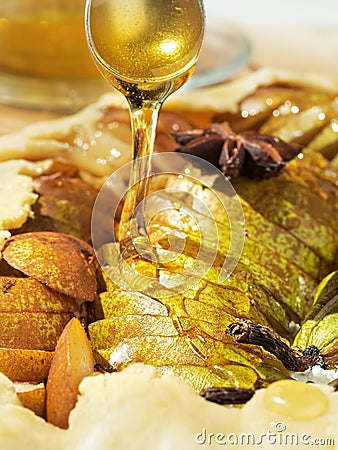 Homemade seasonal French pear cookies - galette with ripe pears, cardamom and honey. Pear slices are poured with honey, the Stock Photo