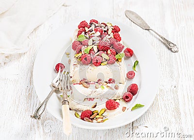 Homemade semifreddo with pistachio, raspberries and mint leaves Stock Photo