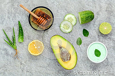 Homemade skin care and body scrub with natural ingredients avocado ,aloe vera ,lemon,cucumber and honey set up on stone Stock Photo