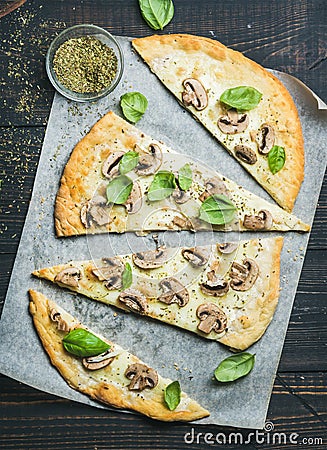 Homemade sliced mushroom pizza with basil and spices in glass Stock Photo
