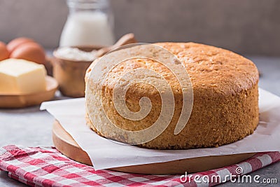 Homemade Soft and lite delicious sponge cake with ingredients: eggs flour milk on stone concrete table. Bakery background concept Stock Photo