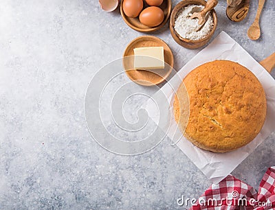Homemade Soft and lite delicious sponge cake with ingredients: eggs flour milk on stone concrete table. Bakery background concept Stock Photo