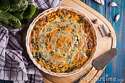 Homemade spinach french pie quiche lorraine on wooden board top view Stock Photo