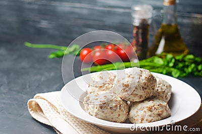 Homemade steamed meatballs with chicken and buckwheat. black concrete background. selective focus Stock Photo