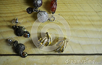 Homemade stone jewelry and earing on wooden table background Stock Photo