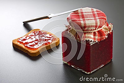 Strawberry Jam Jar, Rusk and Knife Stock Photo