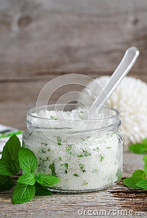 Homemade sugar scrub with vegetable oil, chopped mint leaves and essential mint oil Stock Photo