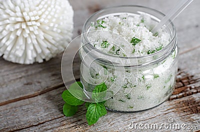 Homemade sugar scrub with vegetable oil, chopped mint leaves and essential mint oil Stock Photo