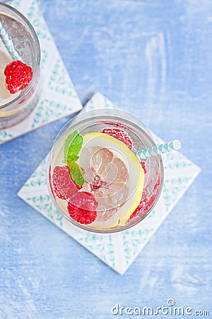 Homemade summer cold raspberry lemon cocktail with sparkling water and crushed iced in glasses Stock Photo