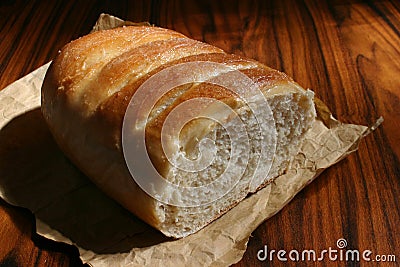 Homemade sweet buns in wrapping paper. Wooden background. Side light. Brazilian breakfast and afternoon snack Stock Photo