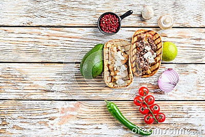 Homemade taco with chicken and beef near raw ingredients over white textured old table, top view with space for text Stock Photo