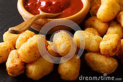 Homemade tater tots with tomato sauce close up. horizontal Stock Photo