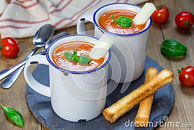 Homemade tomato basil soup in the mug, served with mozzarella cheese stick Stock Photo