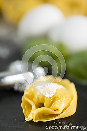 homemade Tortelli Tortellini stuffed over a black stone ardesian tray Stock Photo