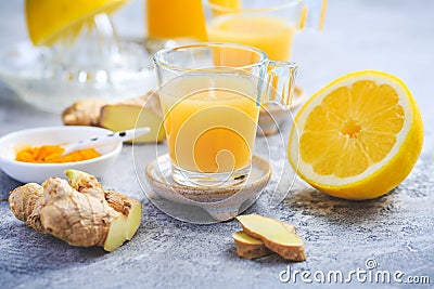 Homemade turmeric lemon ginger shots in small glasses Stock Photo