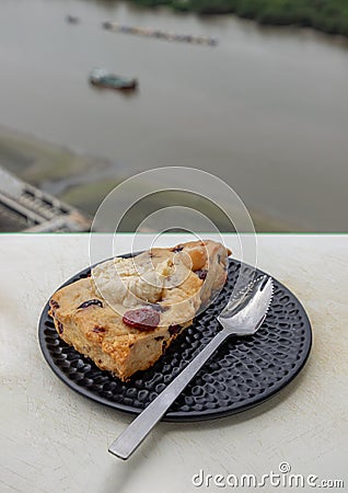 Homemade Vanilla Mixed Cream Cheese Granberry Scone served with spoon on black ceramic plate Stock Photo