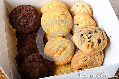 Homemade vanilla, orange, lemon chocolate chip cookies biscuits stack on a white plate Stock Photo