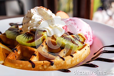 Homemade waffle served with strawberry ice cream and variety frui Stock Photo