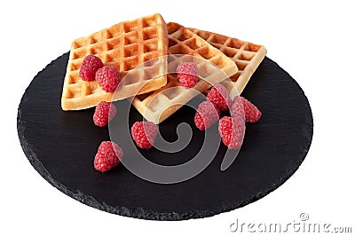 Homemade waffles with berries on black stone plate isolated. Belgian waffle with fruit raspberry on white background. Stock Photo