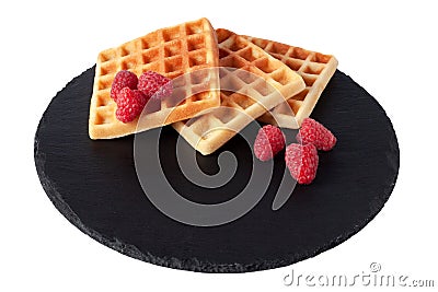 Homemade waffles with berries on black stone plate isolated. Belgian waffle with fruit raspberry on white background. Stock Photo