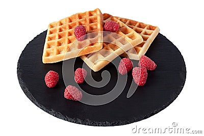 Homemade waffles with berries on black stone plate isolated. Belgian waffle with fruit raspberry on white background. Stock Photo