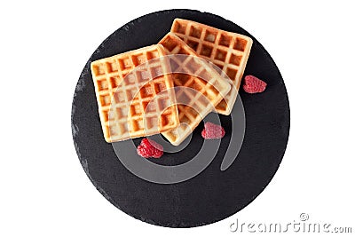 Homemade waffles with berries on black stone plate isolated. Belgian waffle with fruit raspberry on white background Stock Photo