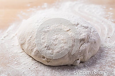 Homemade yeast dough freshly prepared for pizza or bread on wooden background. Stock Photo