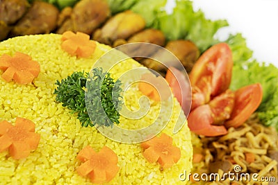 Homemade yellow rice with side dishes on table Stock Photo