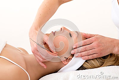 Homeopath using ear acupuncture techniques. Stock Photo