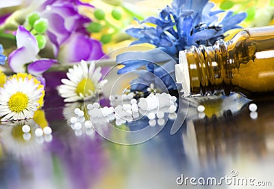 Homeopathic globules with blooms Stock Photo