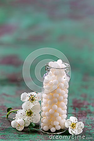 Homeopathy globules in bottles. homeopathy, naturopathy and alternative medicine. Alternative homeopathy medicine concept. green Stock Photo