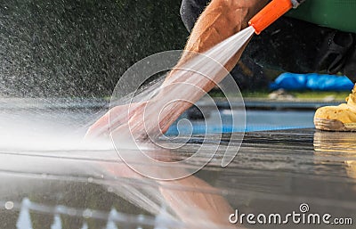 Homeowner Cleaning Patio Poolside Deck Stock Photo