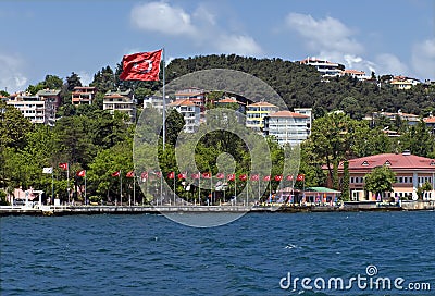 Homes along and turkish flag the Bosporus Turkey Stock Photo