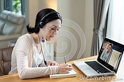 Homeschool Caucasian cute young girl student learning virtual internet online class from school teacher by remote meeting due to c Stock Photo