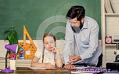 Homeschooling with father. School teacher and schoolgirl. Man bearded pedagogue. Strict pedagogue. Pedagogue skills Stock Photo
