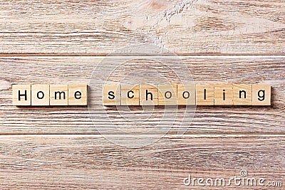 Homeschooling word written on wood block. Home schooling text on table, concept Stock Photo