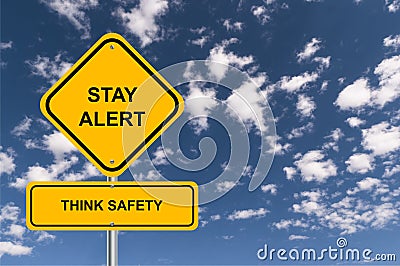 Stay alert think safety traffic sign on blue sky Stock Photo