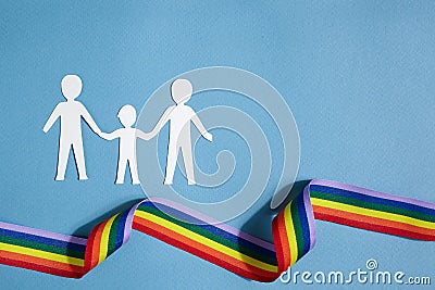 Homosexual family. Different kind of family. Paper cut family simbol with raindow ribbon Stock Photo