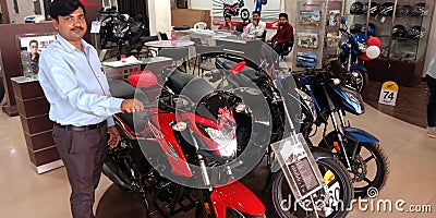 Honda bike motorcycle showroom attender presenting latest bike model Editorial Stock Photo