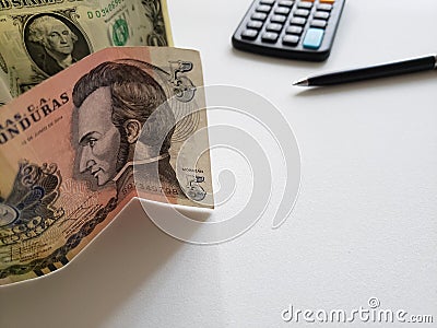 Honduran banknote of five lempiras, American one dollar bill, calculator and black pen Stock Photo