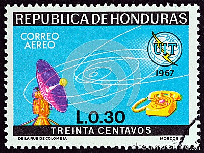 HONDURAS - CIRCA 1968: A stamp printed in Honduras shows dish aerial and telephone, circa 1968. Editorial Stock Photo