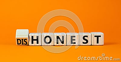 Honest or dishonest symbol. Turned cube and changed the concept word Dishonest to Honest. Beautiful orange table orange background Stock Photo