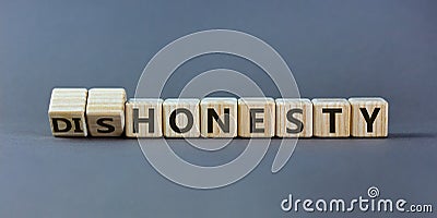 Honesty or dishonesty symbol. Turned cube and changed the word `dishonesty` to `honesty`. Beautiful grey background. Business Stock Photo