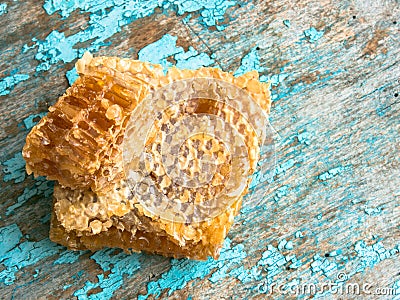 Honey background. Sweet honey in the comb . On rural wooden background. Glass bank with honey Stock Photo