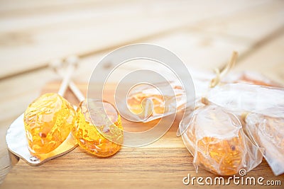 Honey caramel candy lollipop on wooden background Stock Photo